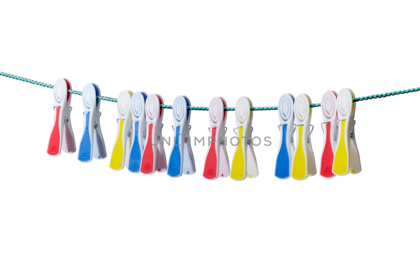 Several spring-type plastic clothespins with varicolored rubber inserts hanging on the clothes line on a light background
