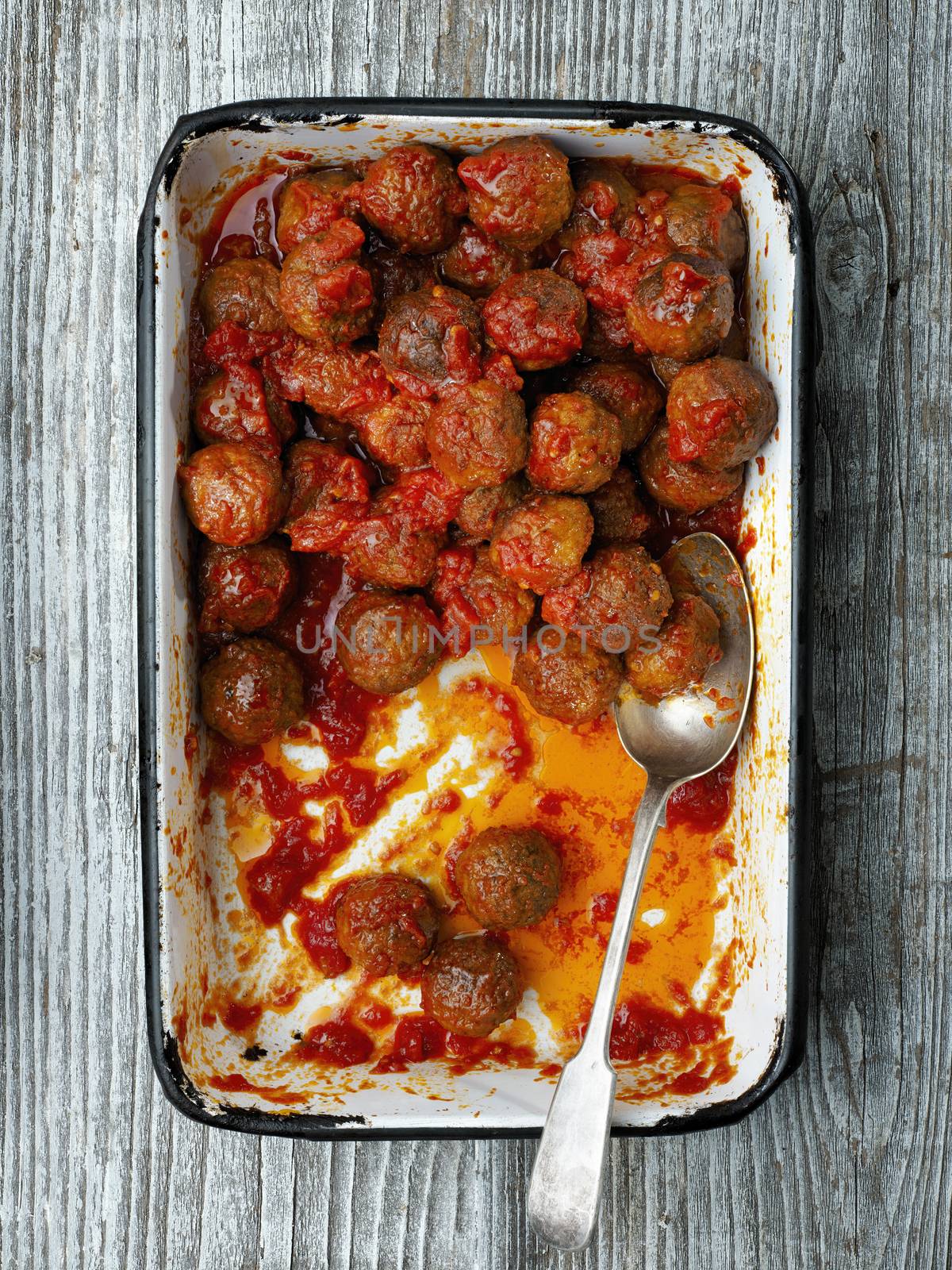 close up of rustic italian meatball in tomato sauce