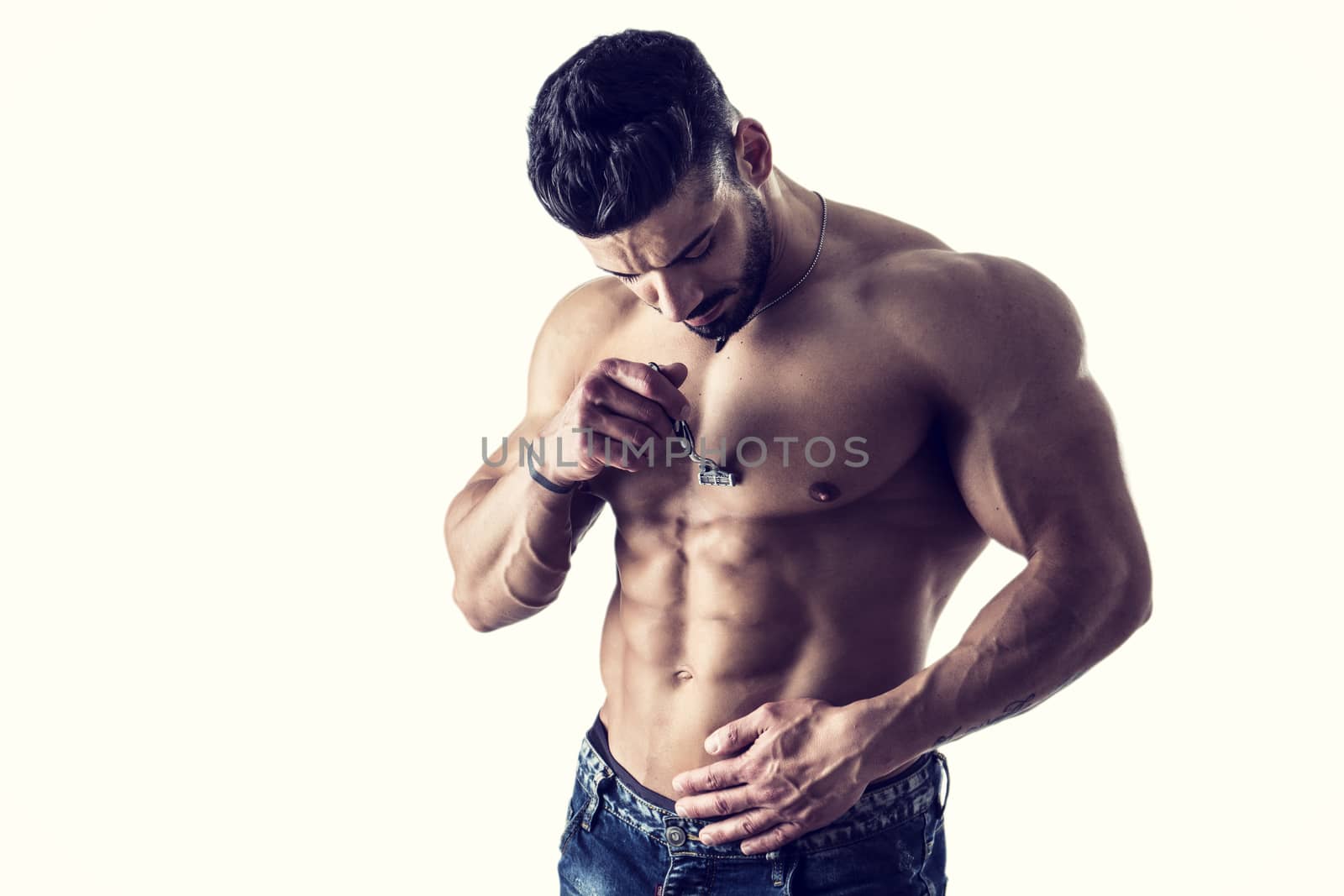 Close up Handsome Muscled Young Man Shaving his Chest with Manual Shaver, Isolated on White Background.