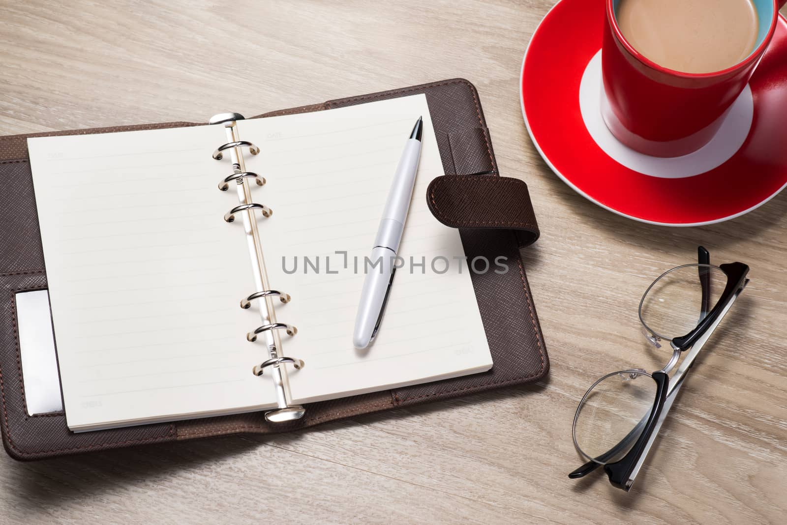 Blank white notebook open, pen and cup of coffee on the desk by makidotvn