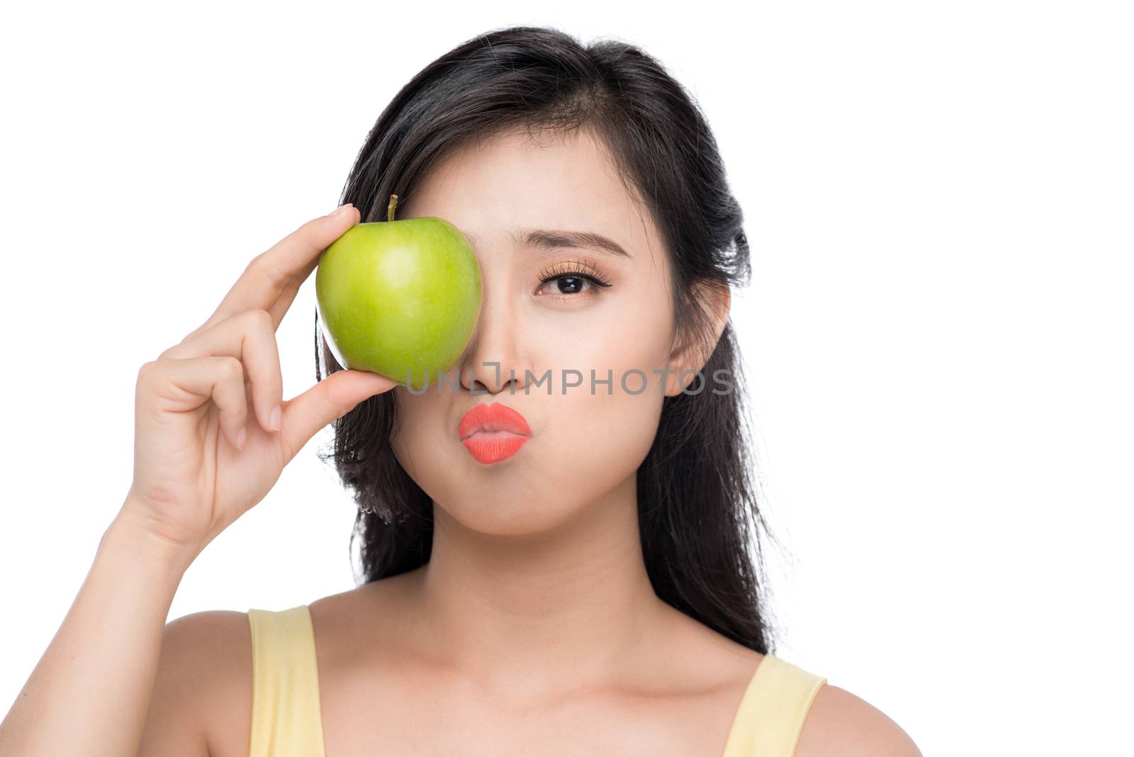 Pretty young asian woman holding fresh apple isolated on white b by makidotvn