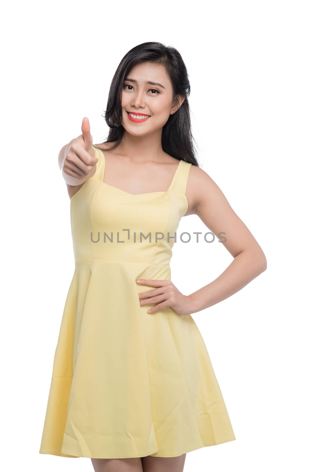 Happy smiling beautiful young asian woman showing thumbs up gesture