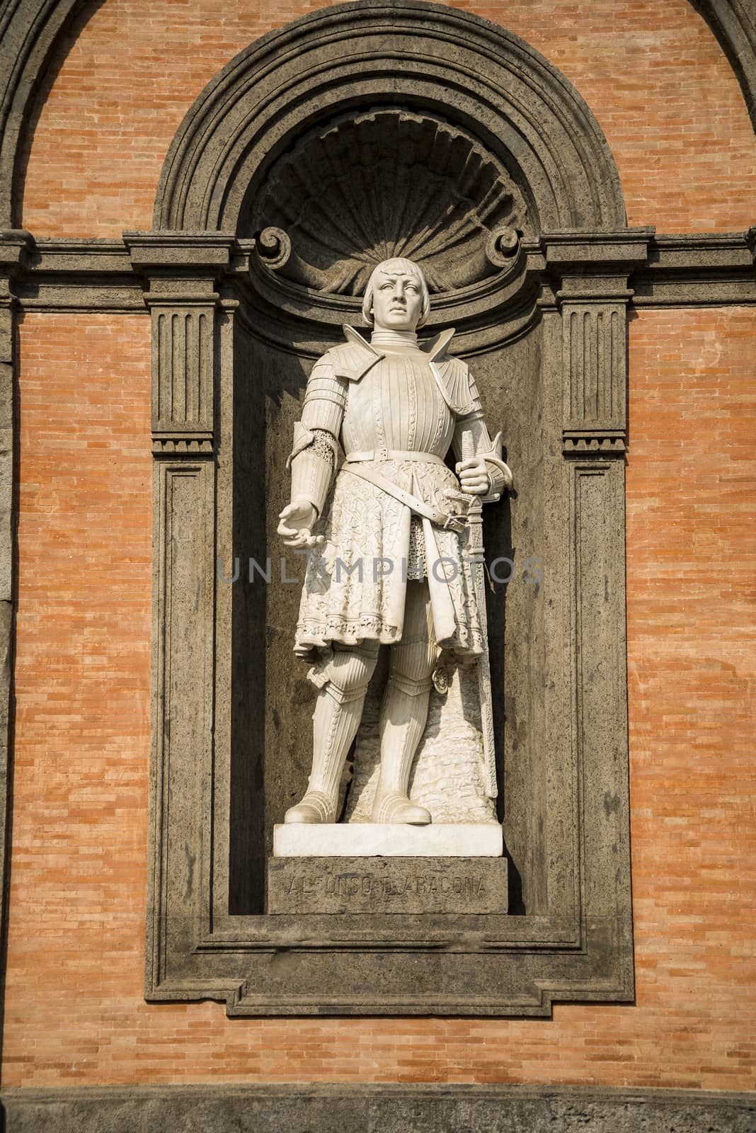 Statue of king Alfonso of Aragon in a niche of the wall of the Royal Palace of Naples, Italy
