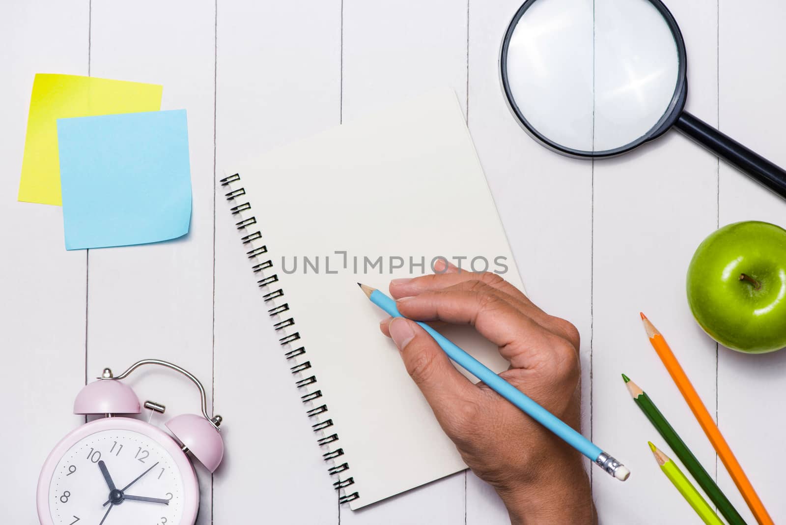 School stationery or office supplies on wood background.