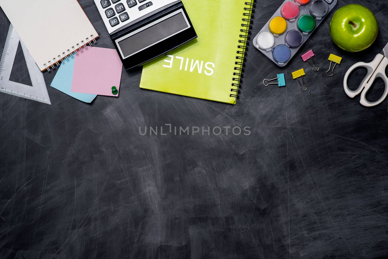 School stationery or office supplies on chalkboard background. by makidotvn