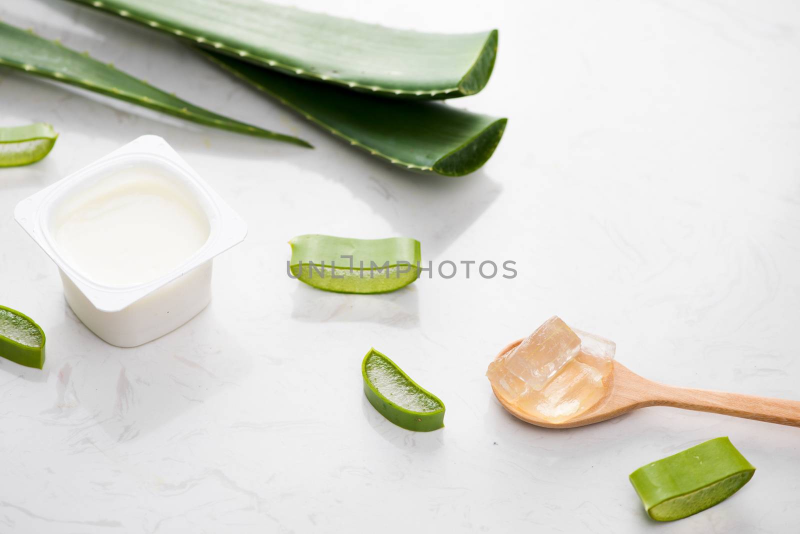 Aloe vera yogurt with fresh leaves on a wooden table