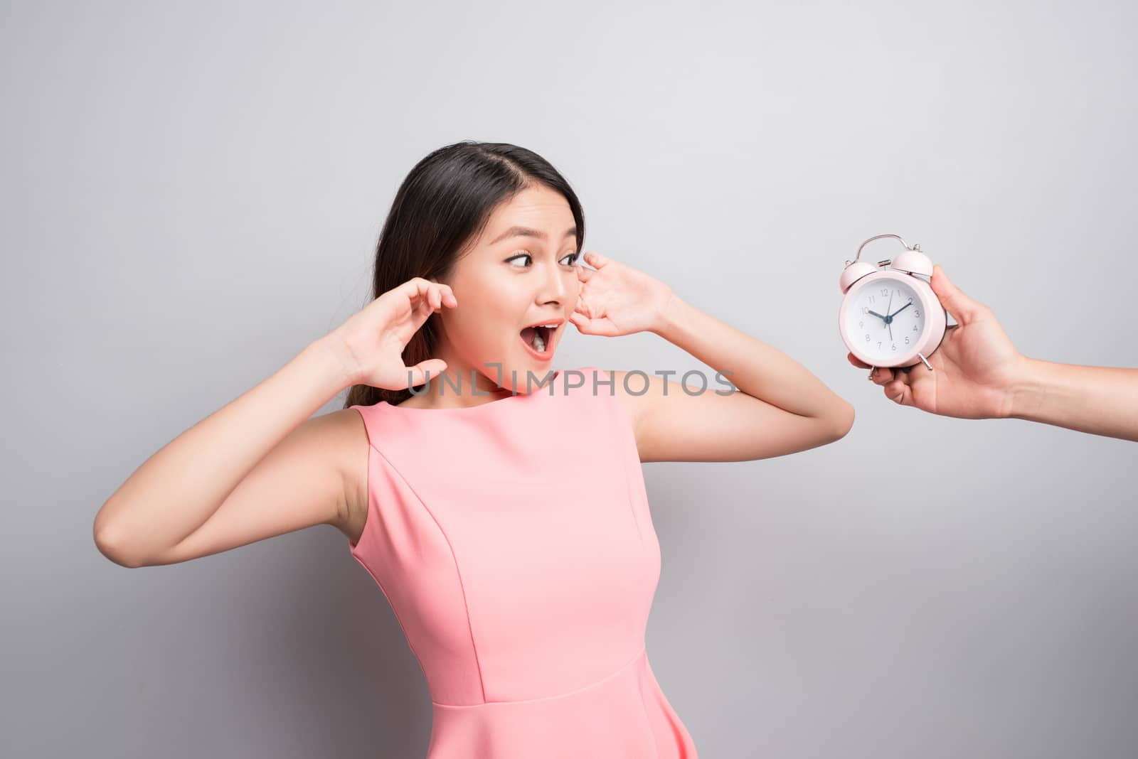 Scared young woman looking at camera over white background