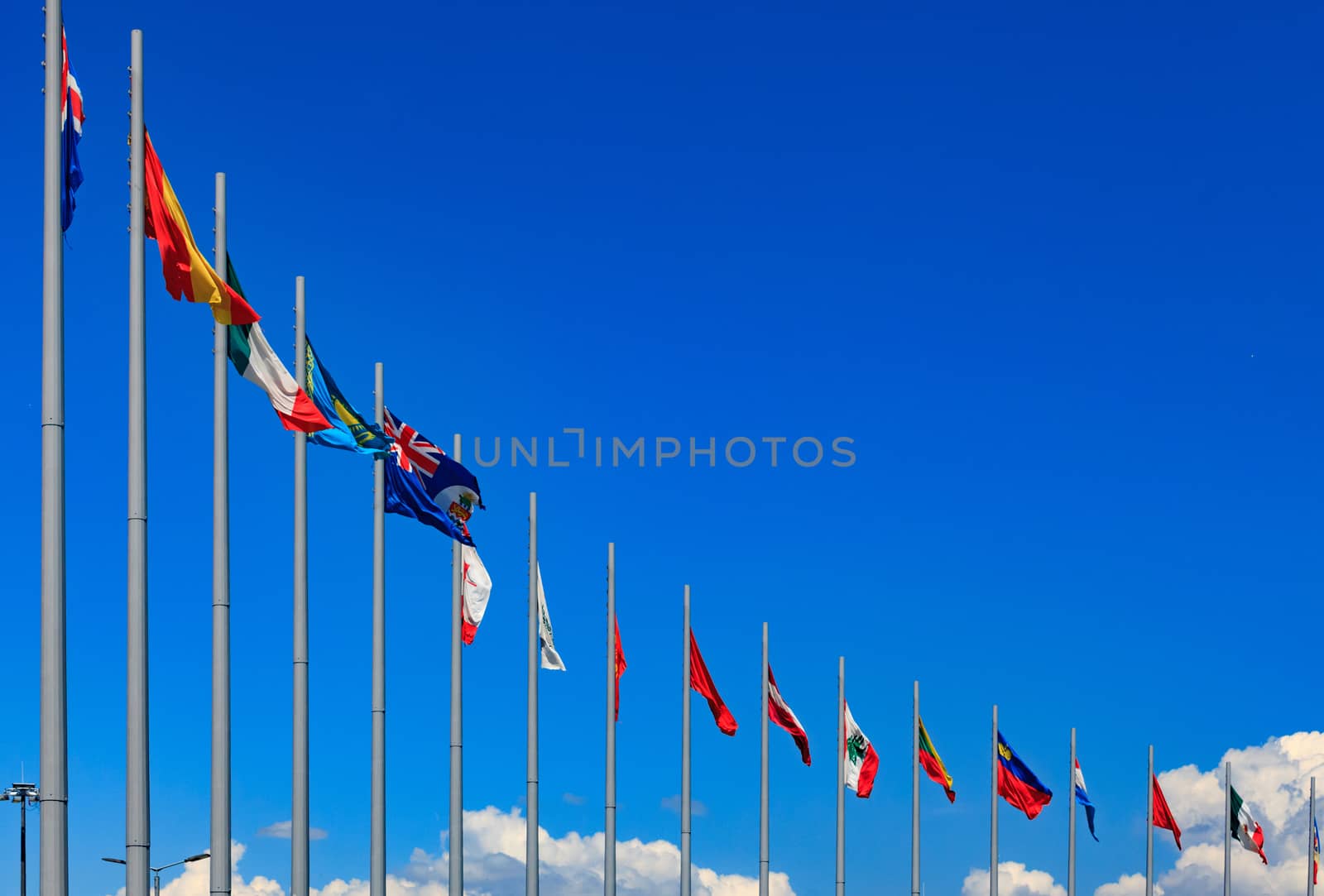 International flags against a blue sky by Nobilior