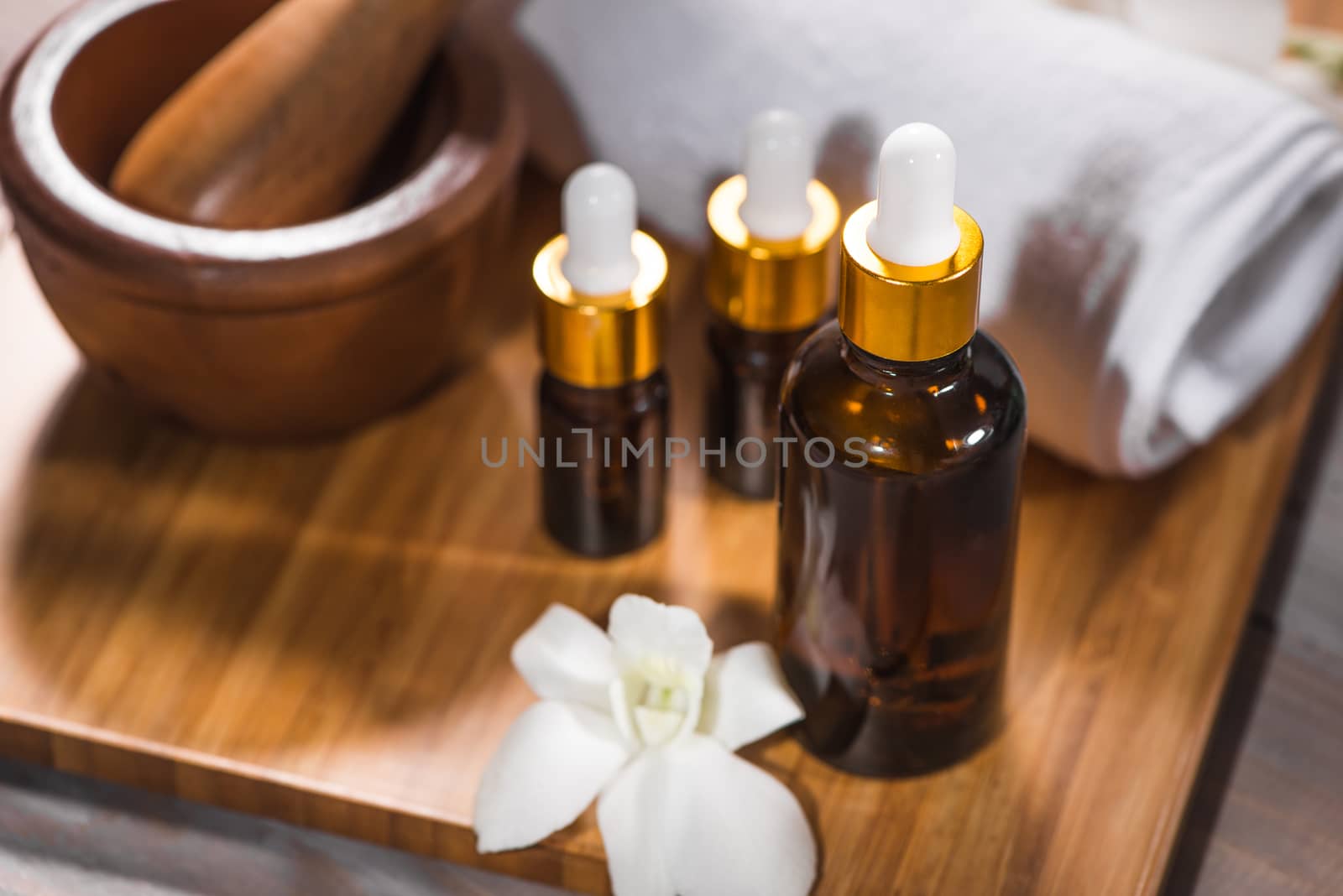 Spa still life with towel, white orchid, bath oil by makidotvn