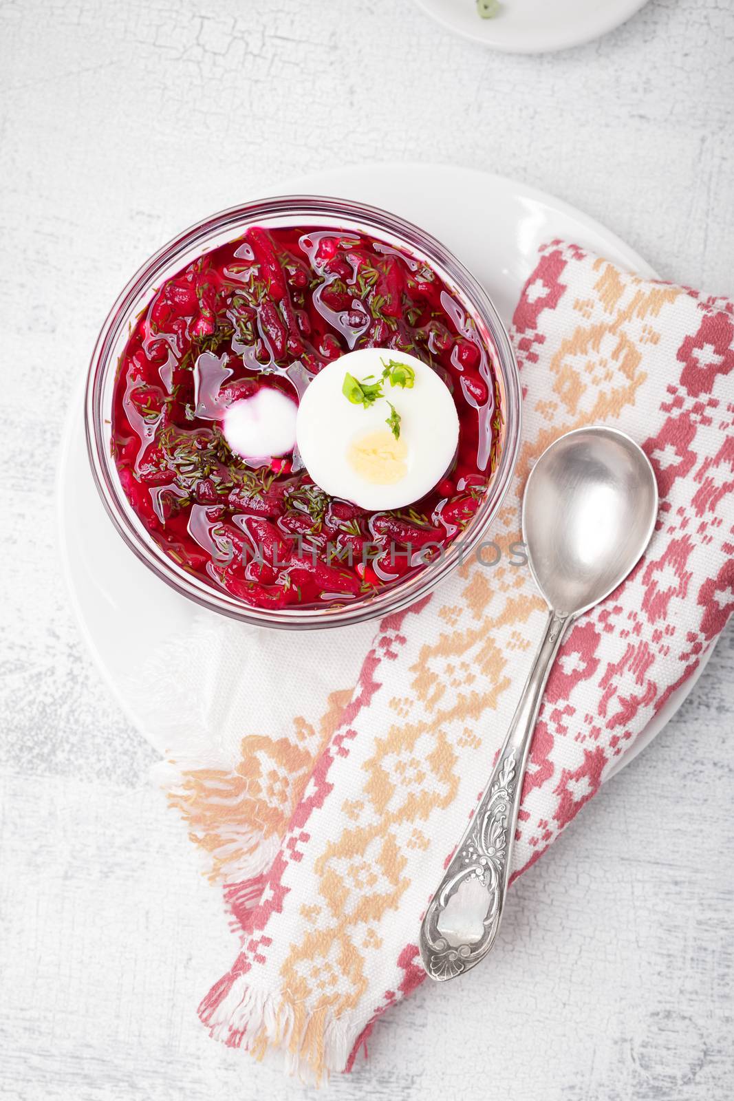 Bowl of beetroot soup with sour cream and eggs.