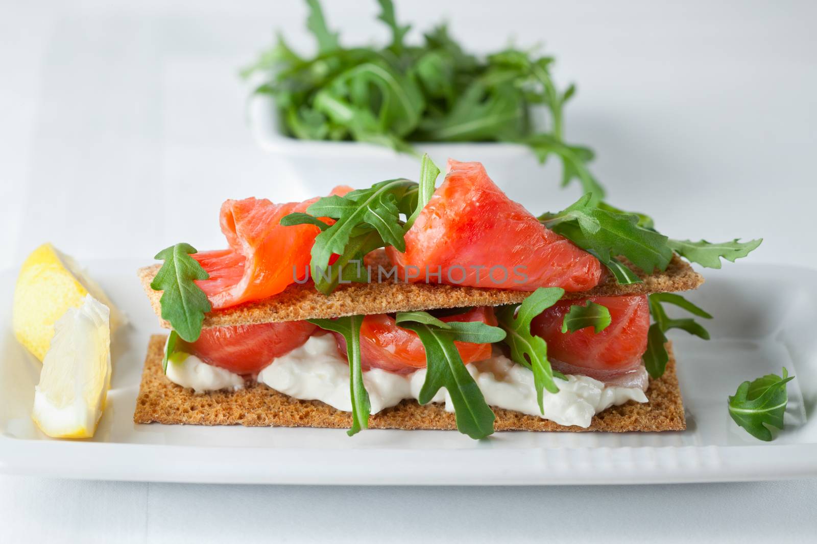 Smoked Salmon on a Healthy Crispbread with Cream Cheese, Fresh Arugula 
