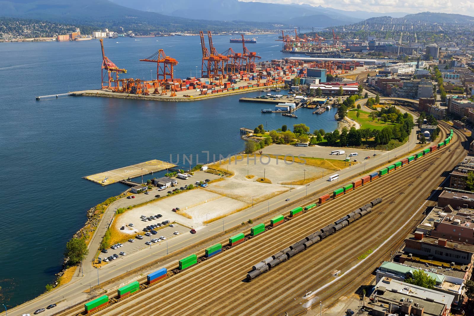 Port of Vancouver British Columbia Canada with containers shipyard cranes and train railroad tracks transportation