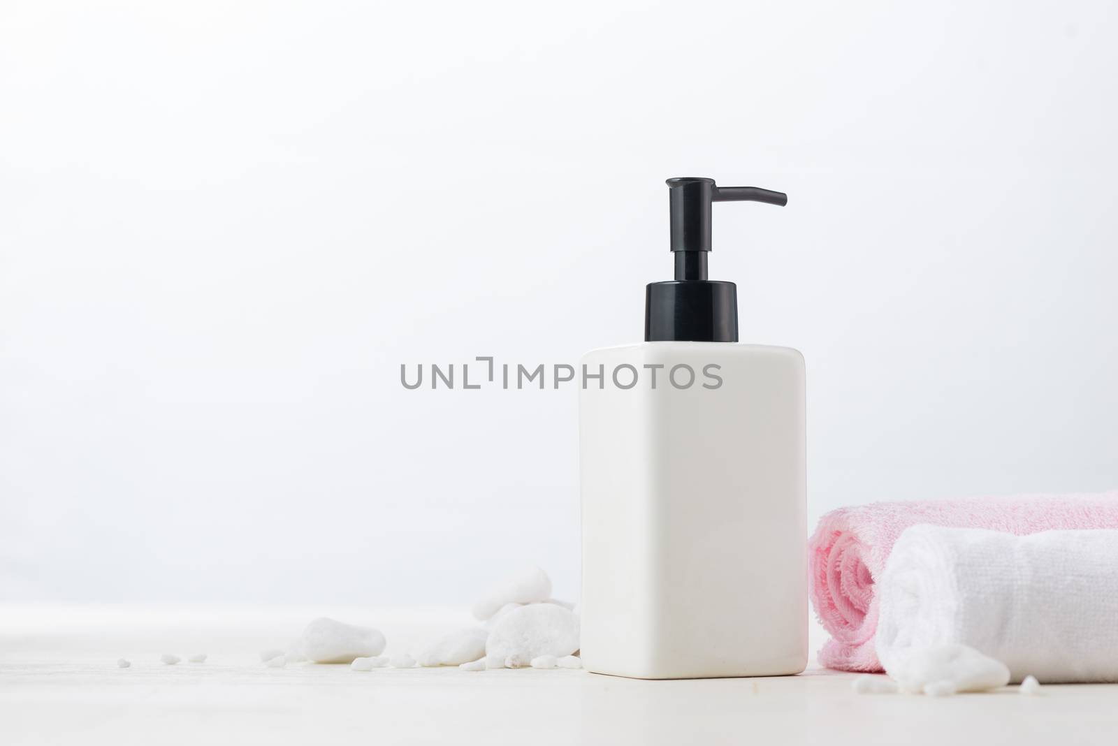 Spa composition with shampoo bottle on white. by makidotvn