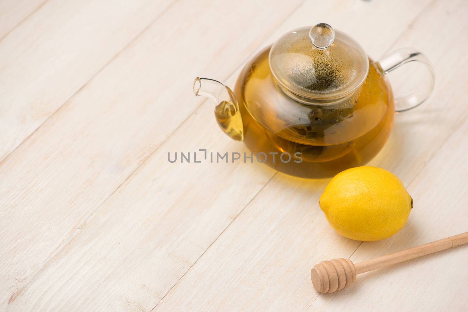 Cup of lemon tea with honey on white wooden background. by makidotvn