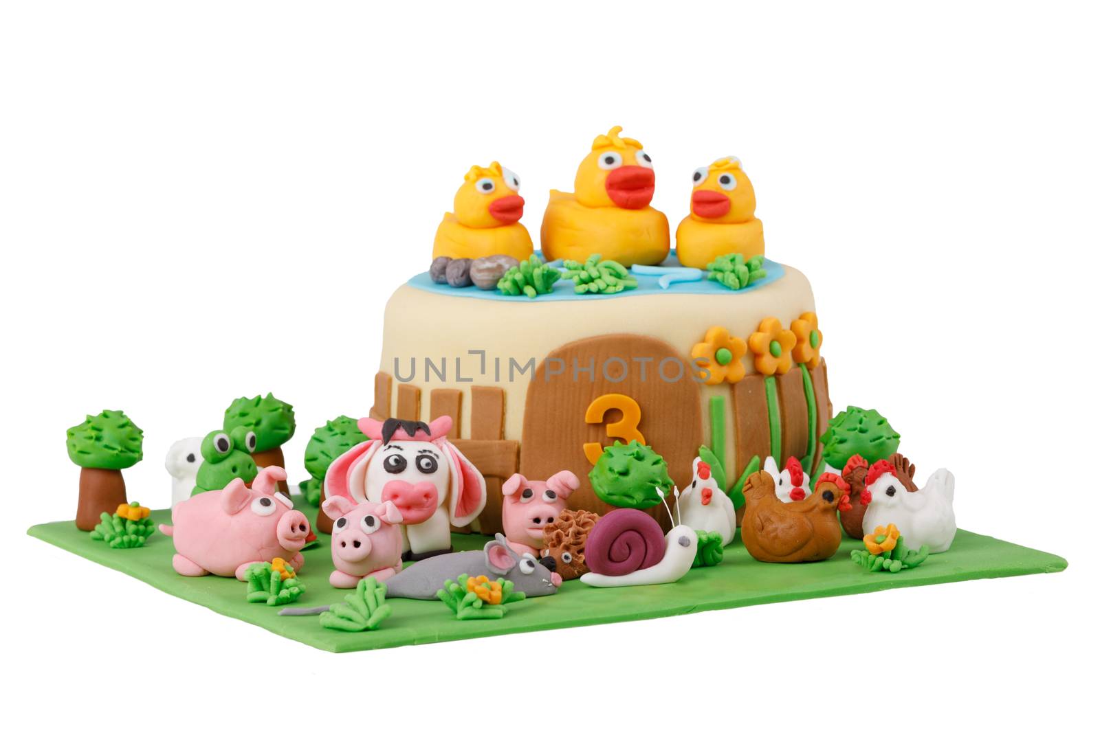 birthday cake with farm marzipan animals and number 3 isolated on white background