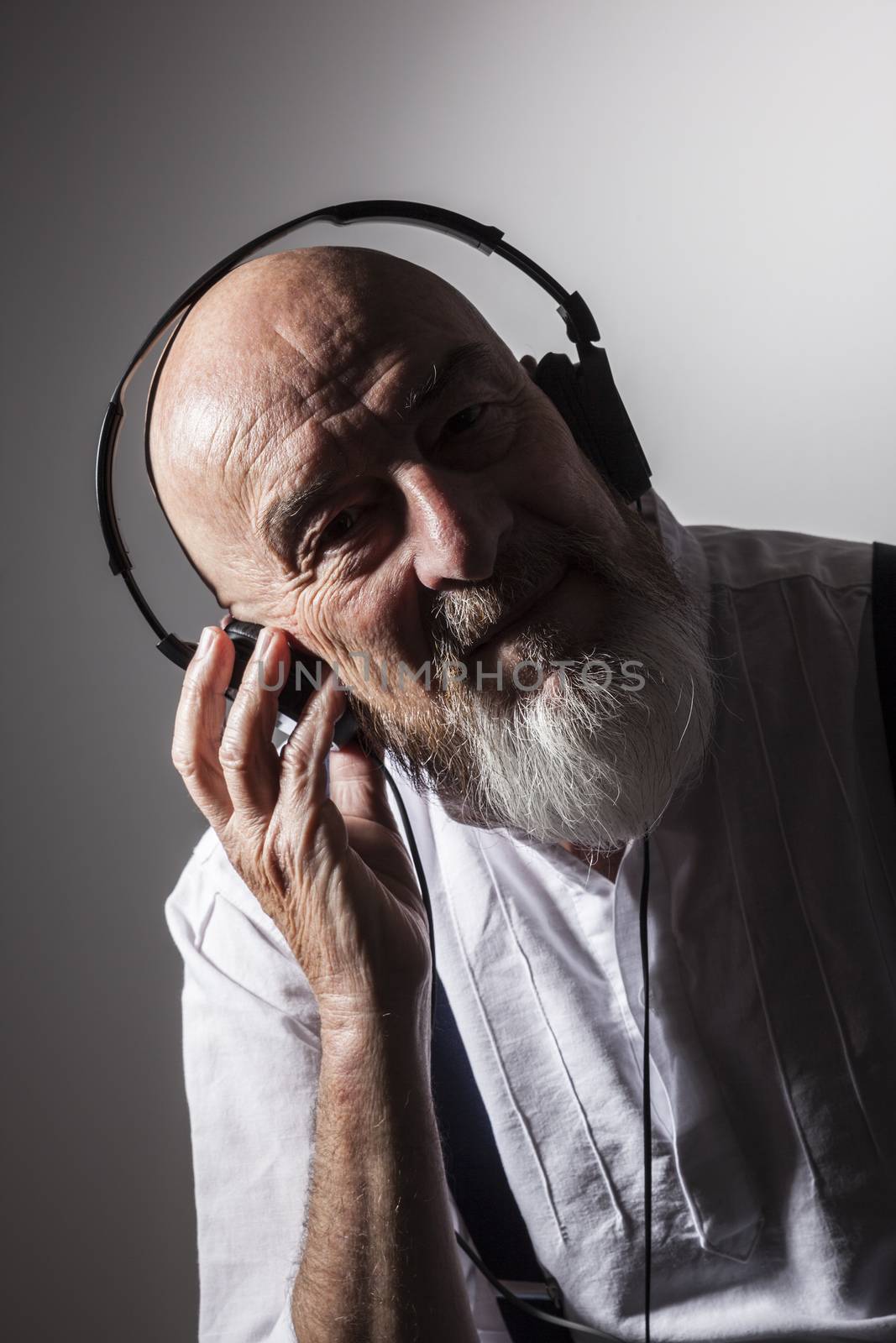 An image of an old man listening to music