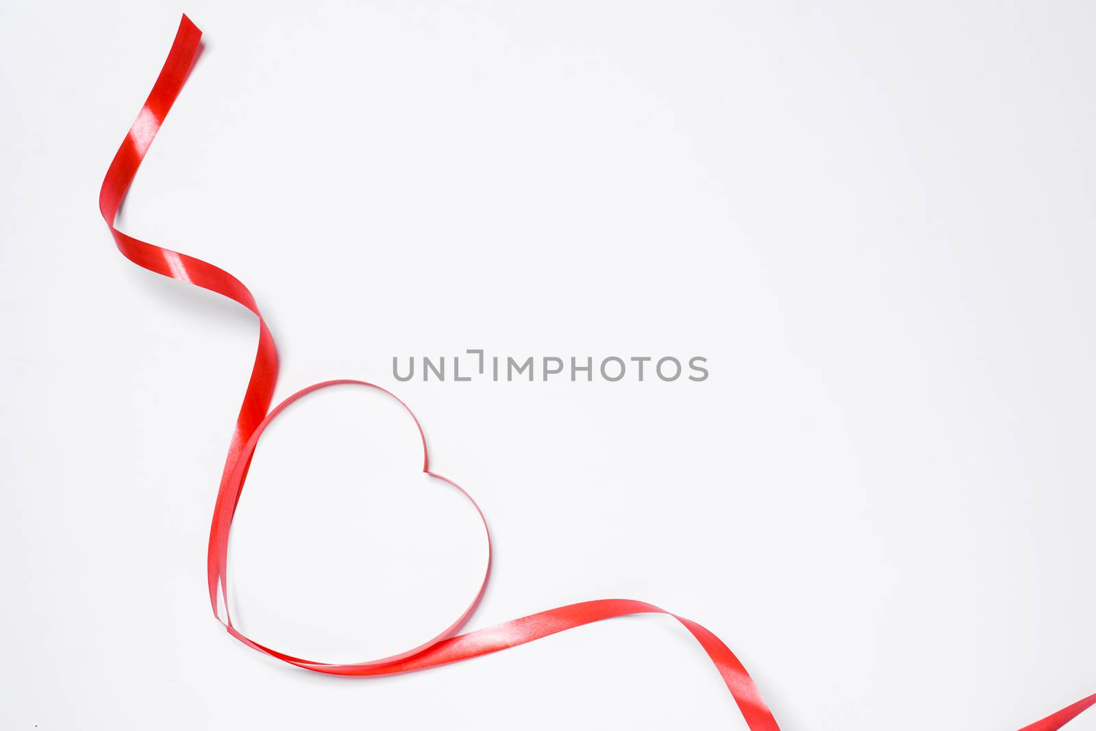 Festive red ribbon isolated on white background by makidotvn