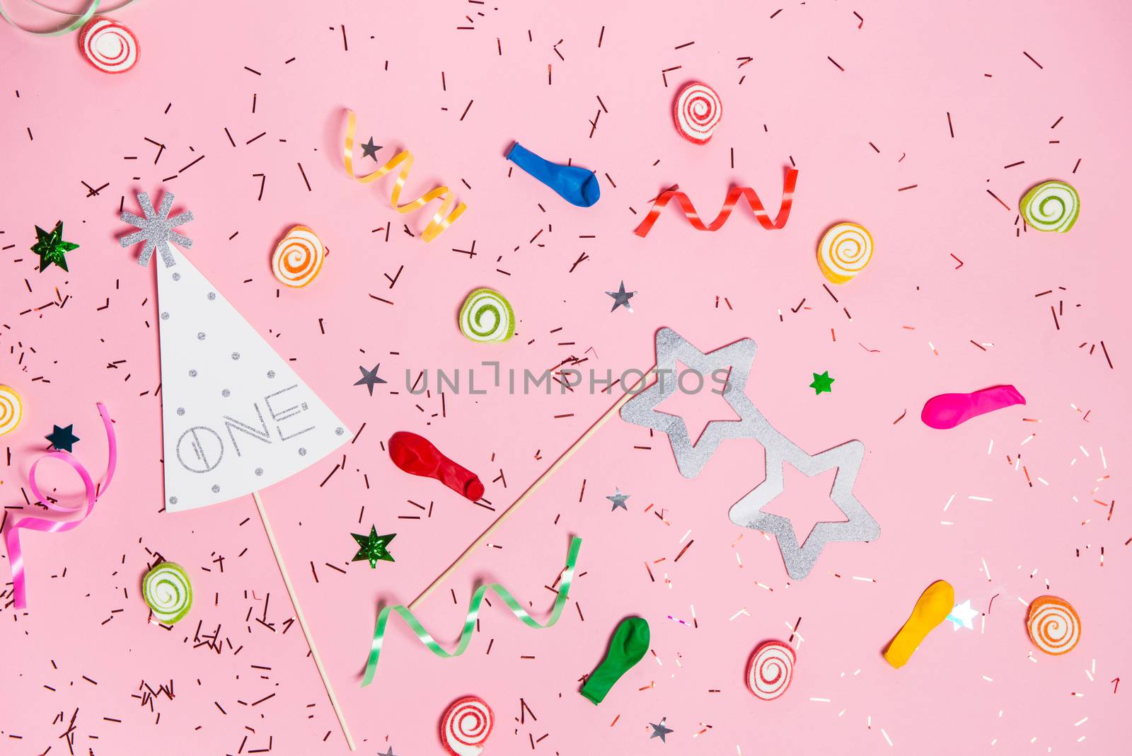 Celebration Flat lay. Candy with colorful party items on pink ba by makidotvn