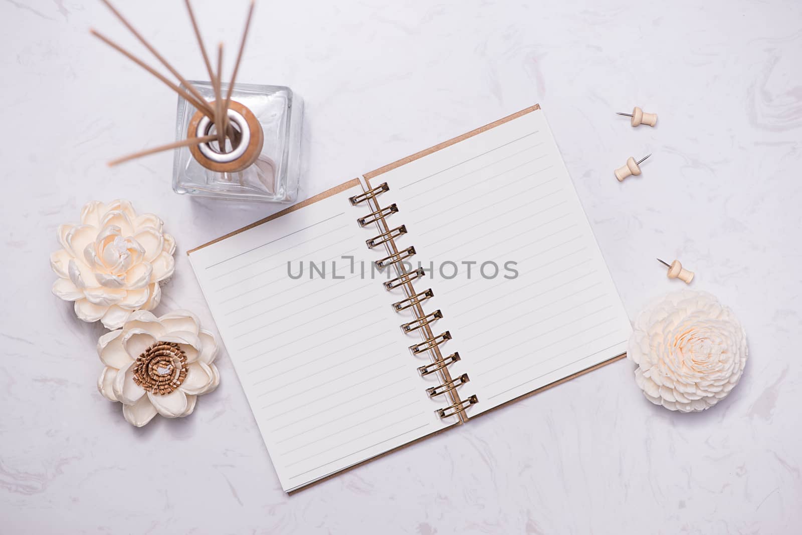 Flat lay, top view of open notebook with aroma bottle glass and  by makidotvn