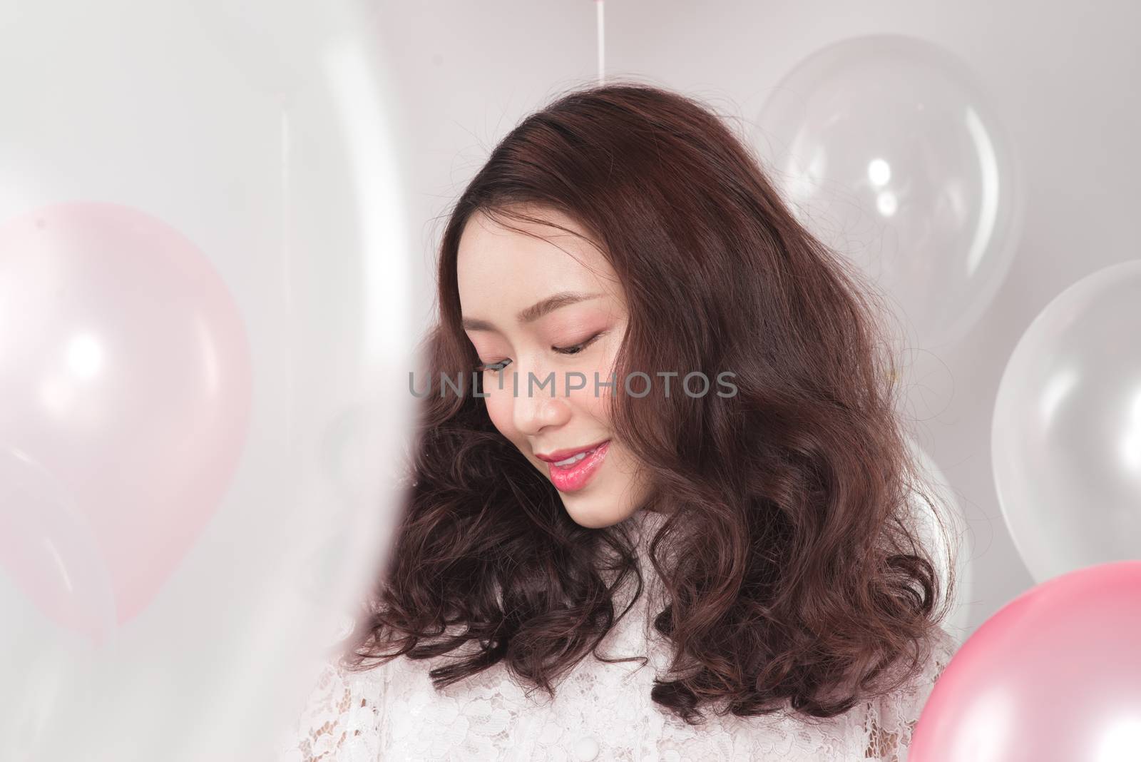 Asian pretty fashionable woman in white dress with pastel balloo by makidotvn