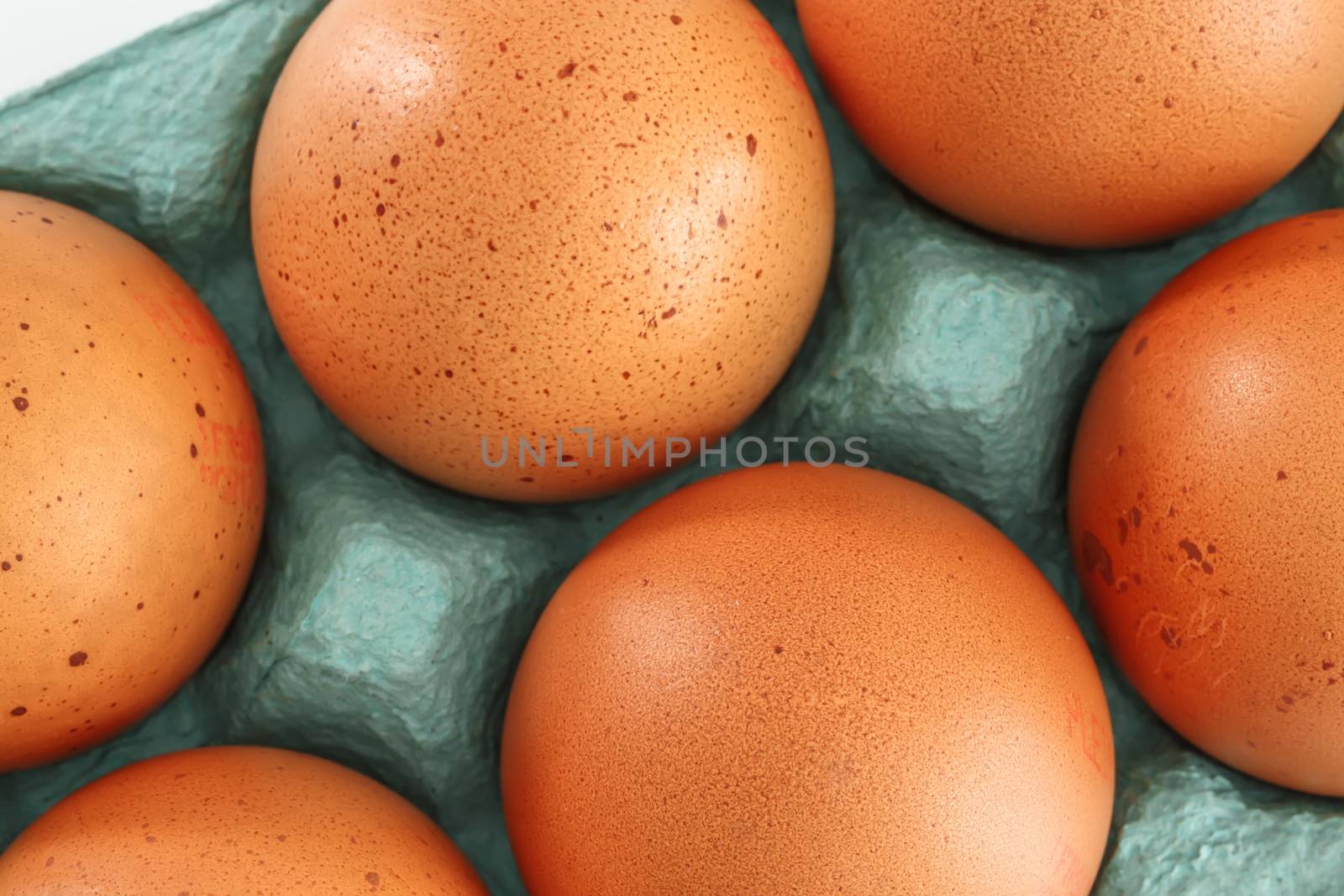 View of opened box of chicken eggs for market place by pixinoo