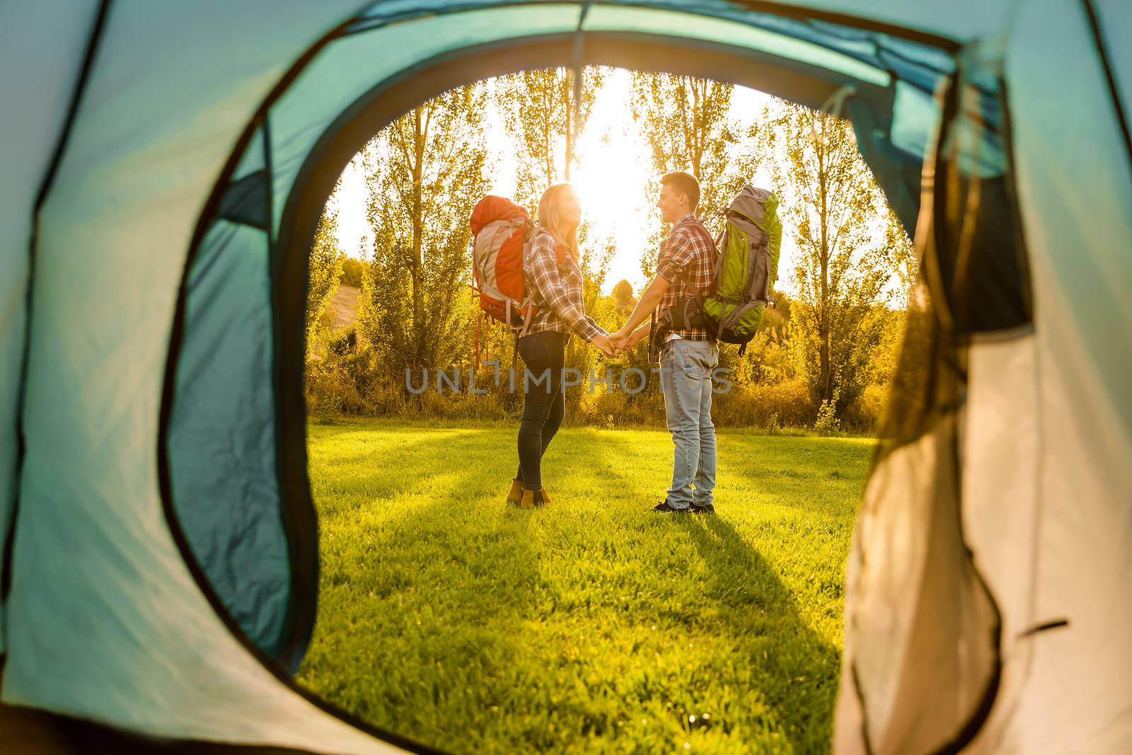 Shot of a happy couple camping on the nature