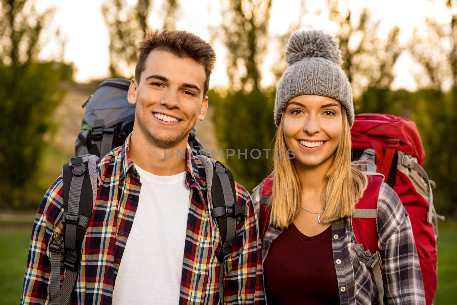 Portrait of a young couple with backpacks ready for camping