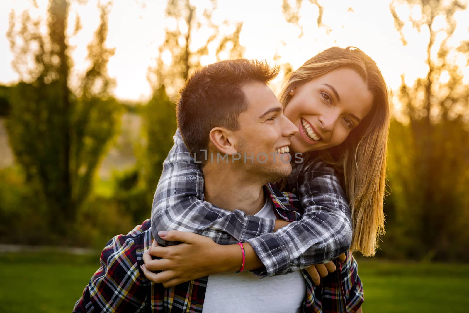 Portrait of a happy young couple in the nature hugged together