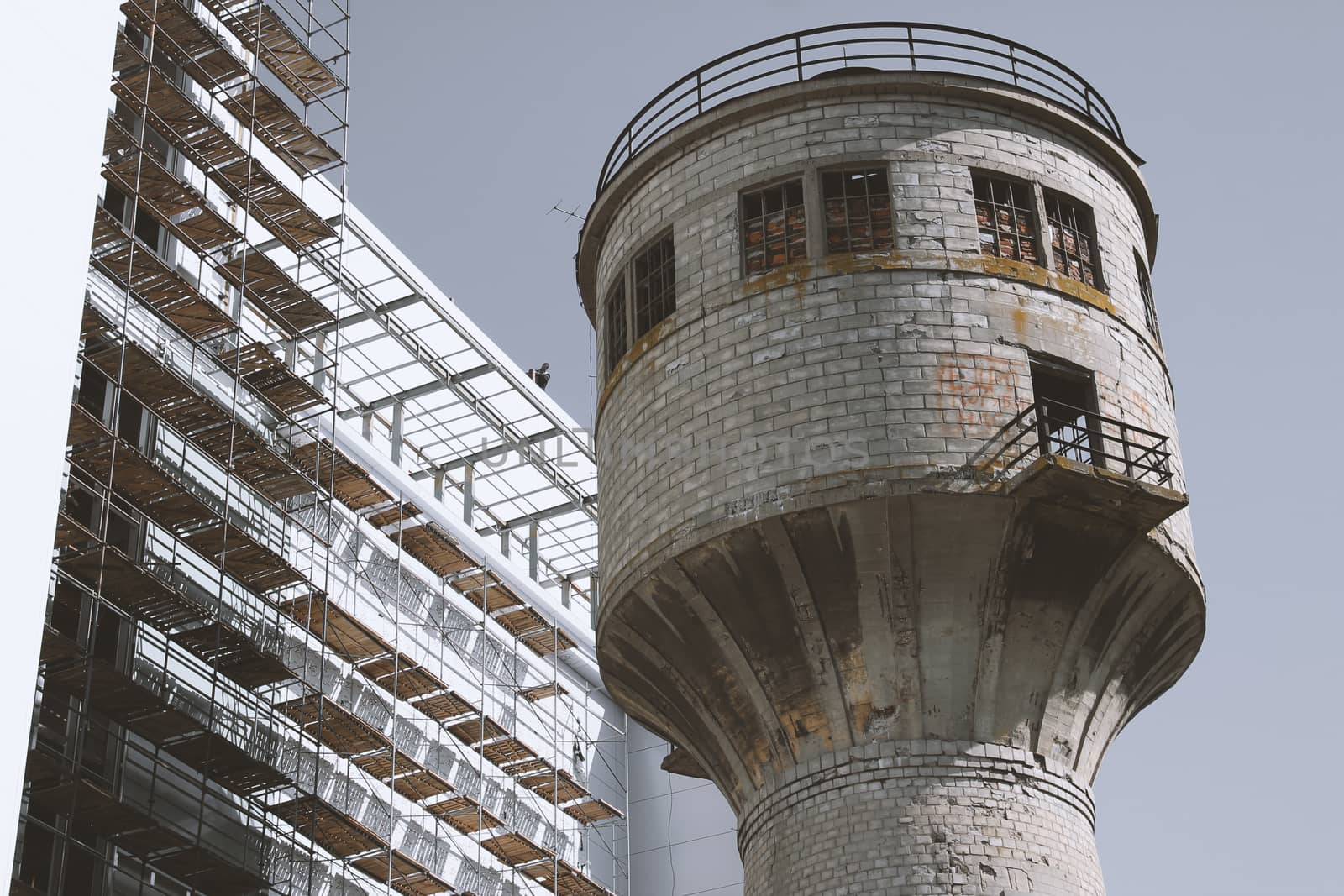 water tower next to a building under construction.