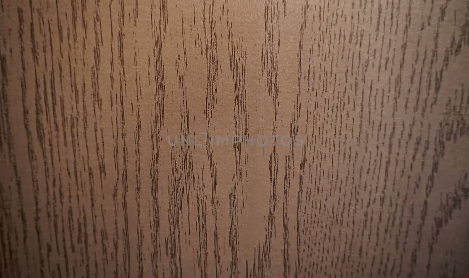 Close-up of wavy wood texture. Brown color.