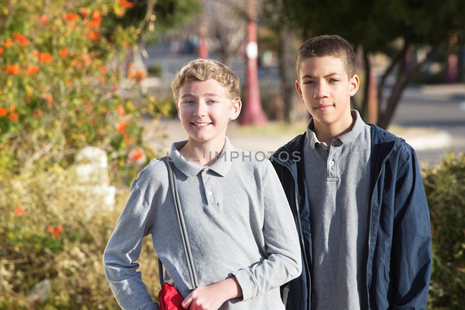Pair of teen male students outside by Creatista