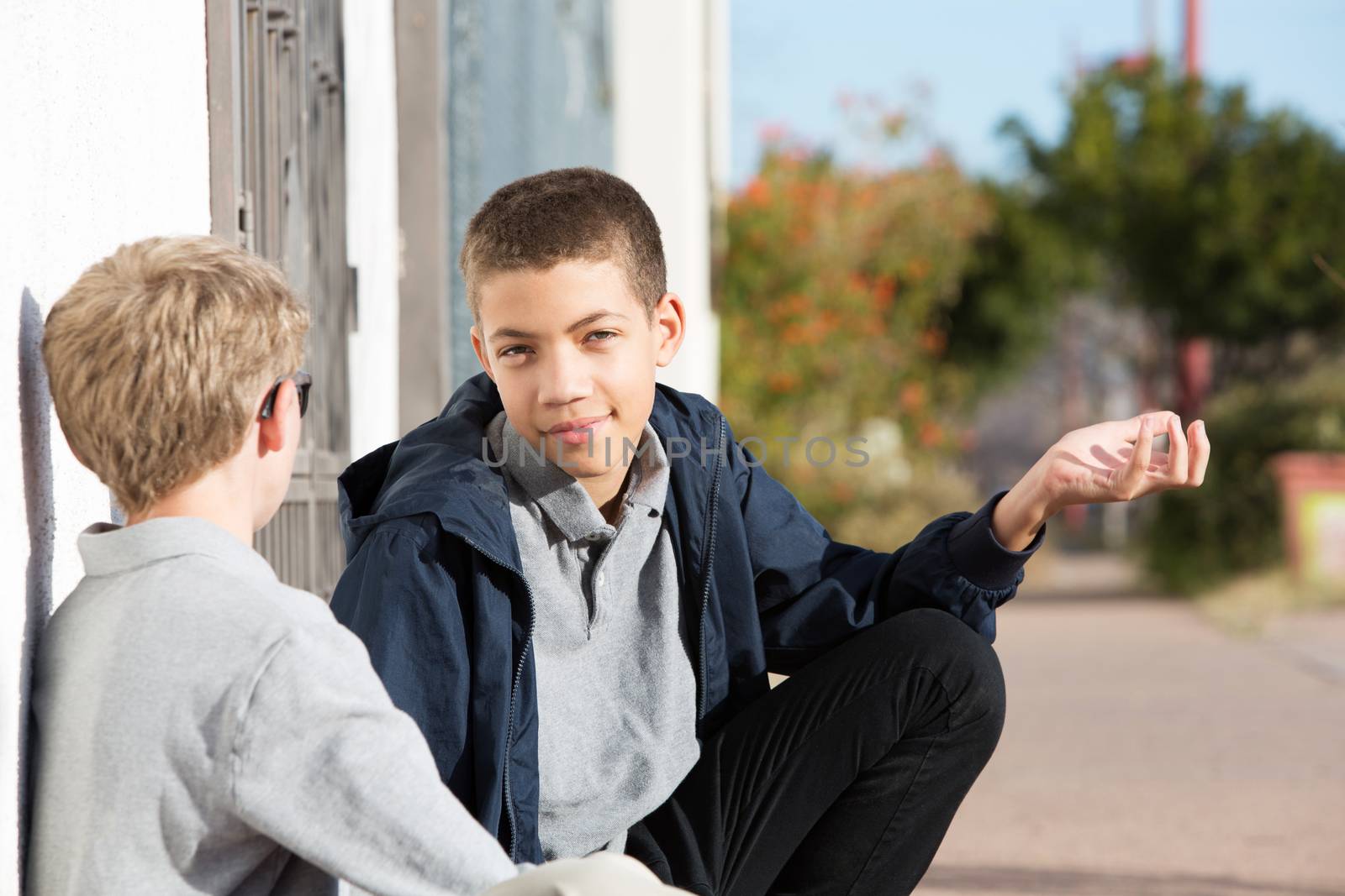 Grinning male child with indifferent expression and hand gesture