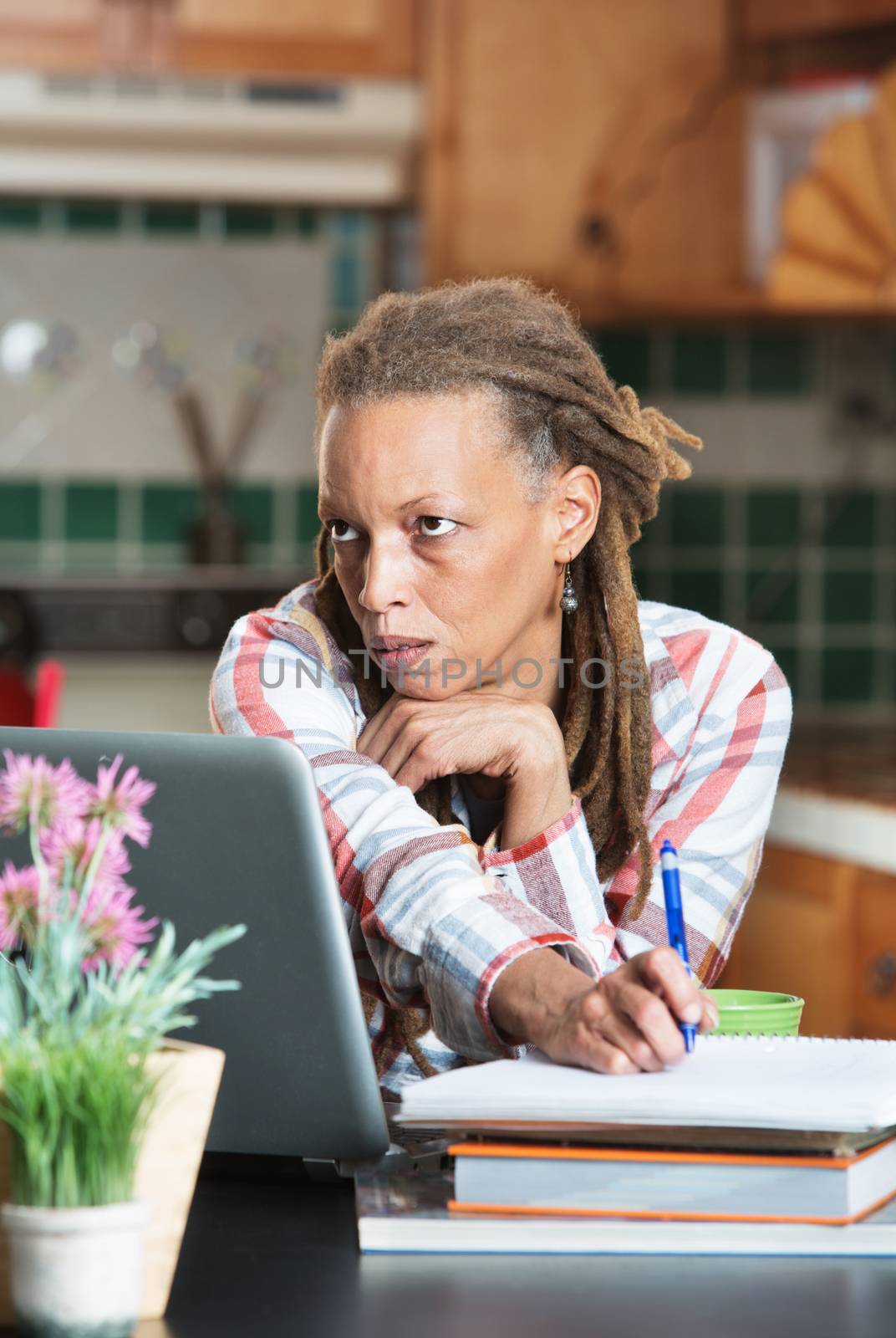 Bored adult student in kitchen with books by Creatista