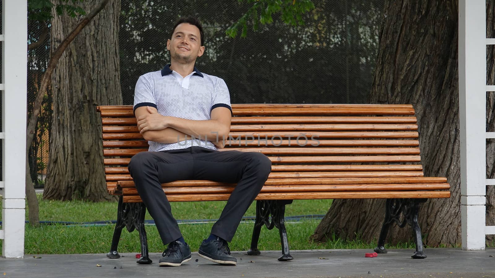 Happy Man Sitting On Park Bench