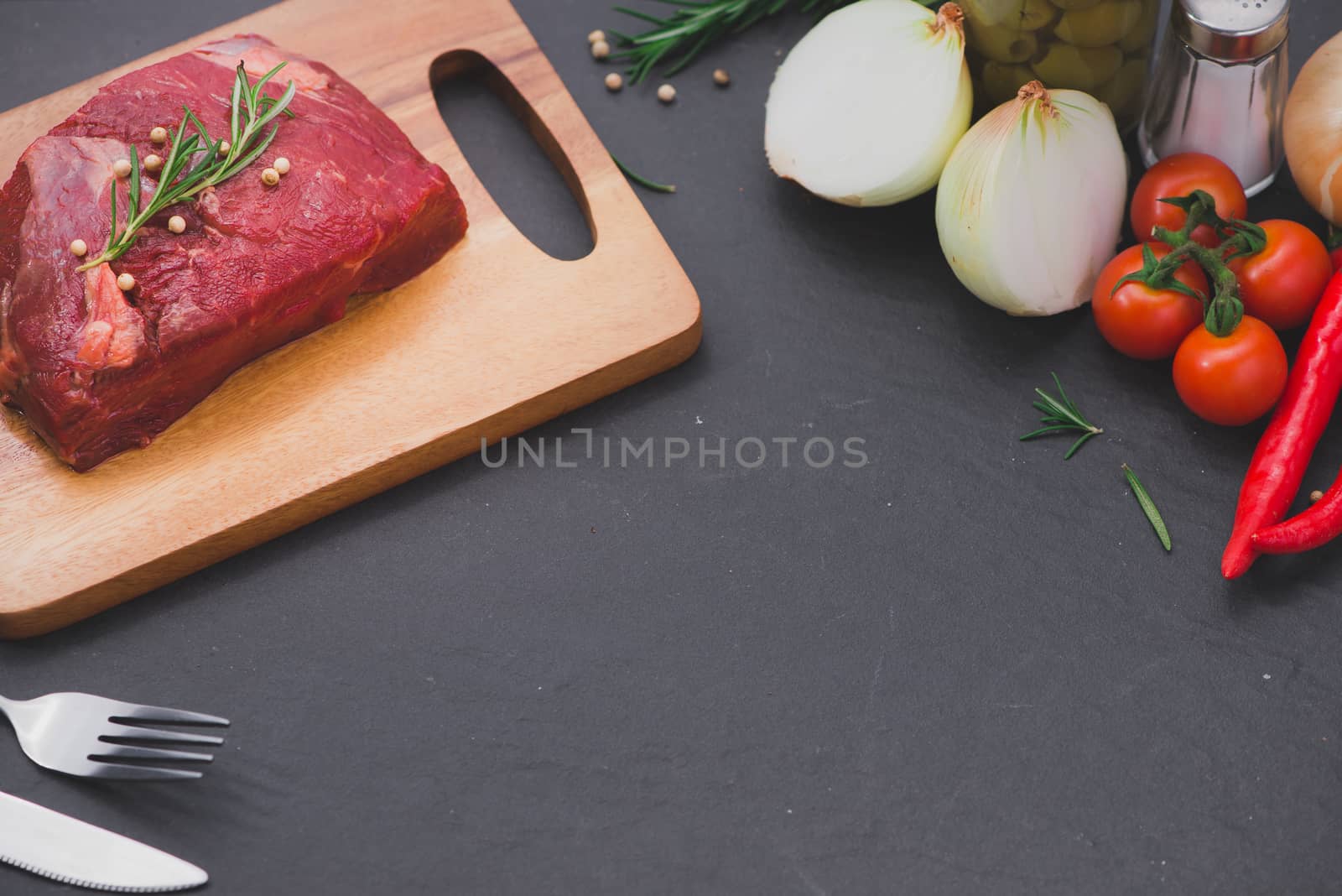 Raw beef on a cutting board  with spices and ingredients for coo by makidotvn