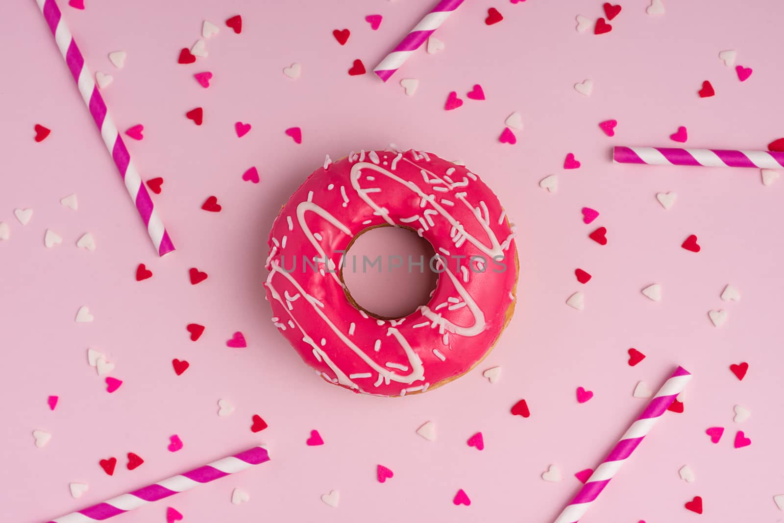 Donuts with icing on pastel pink background with copyspace. Swee by makidotvn