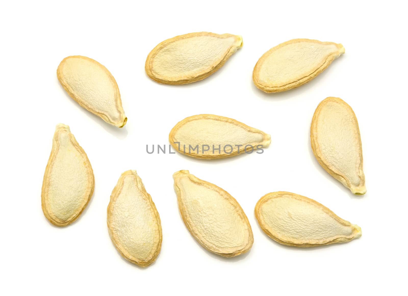 Top view of dried pumpkin seeds on a white background