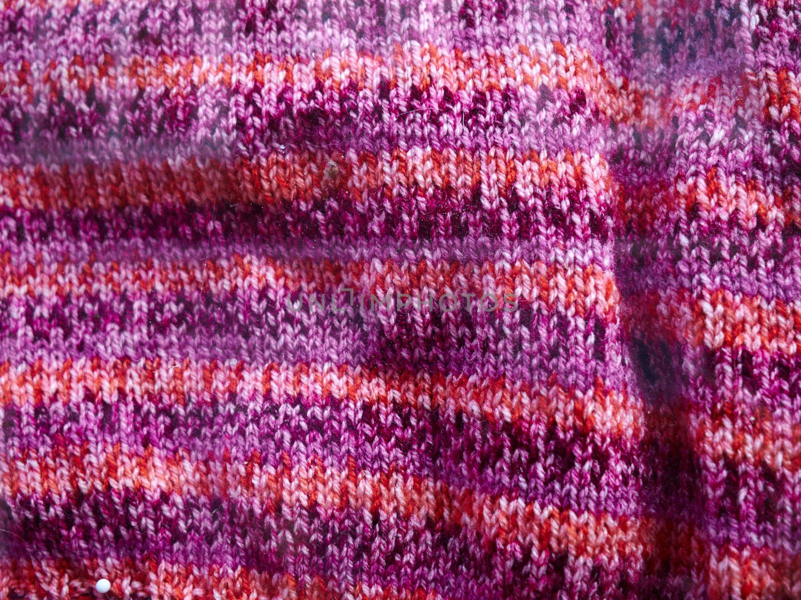 Natural Knitted Wool in Bright Pink, Orange and Purple Colors Background