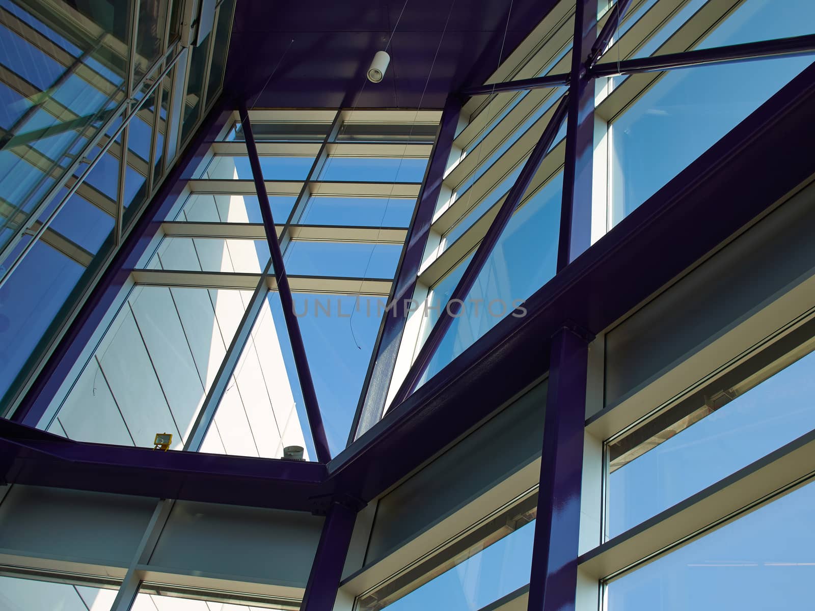 Glass roof of modern building with background of clear blue sky          