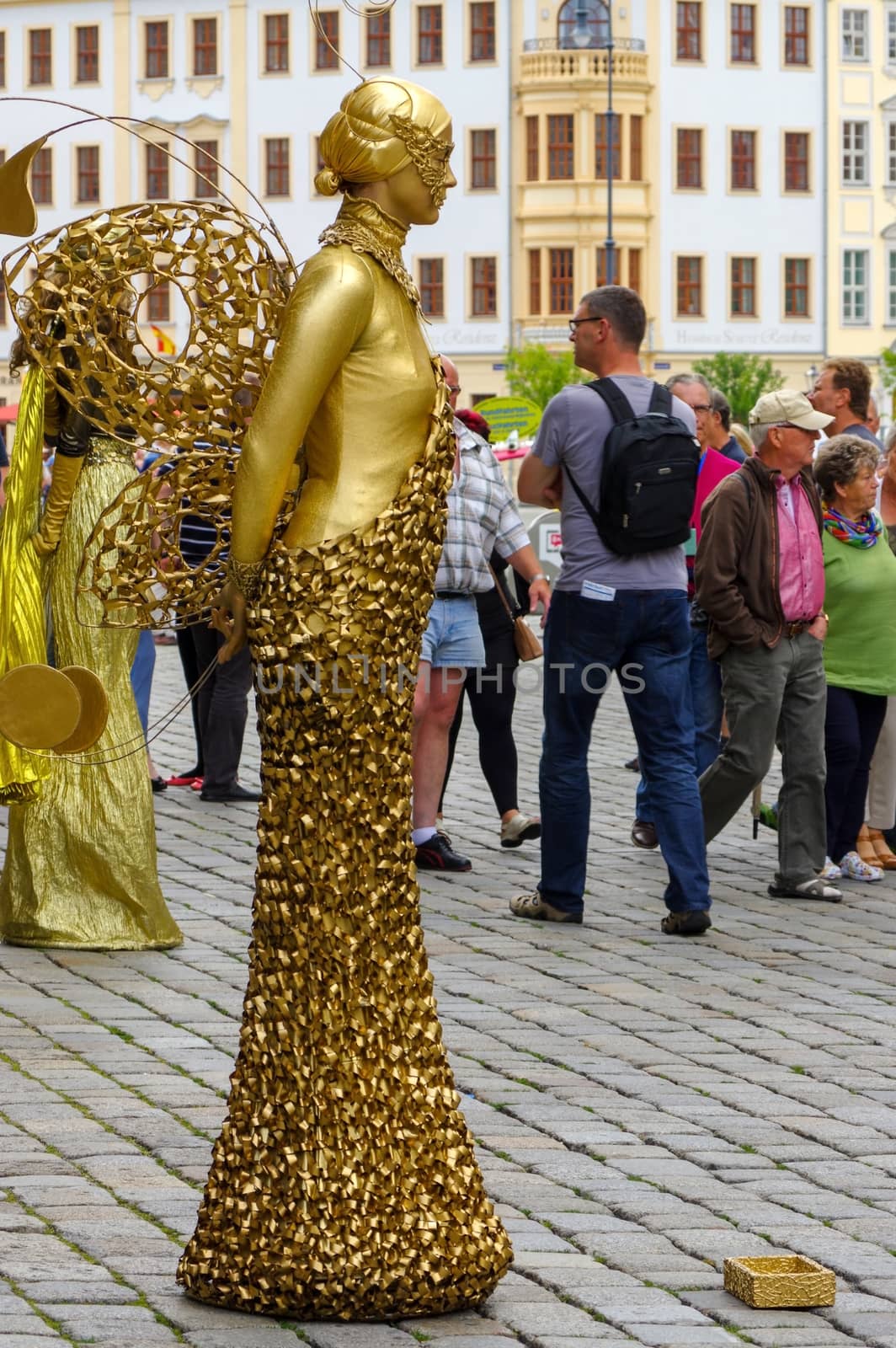DRESDEN, GERMANY - JULY 13, 2015: a performer - Golden painted artists on a city street, living statues by evolutionnow
