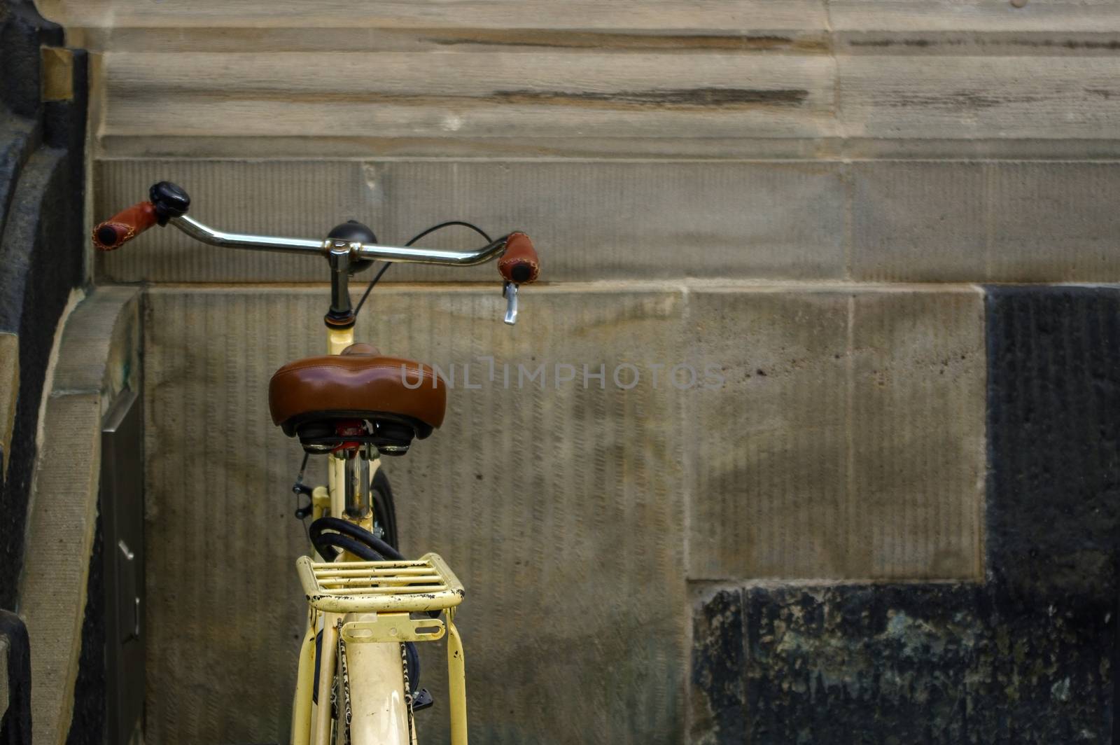 details of old yellow bicycle. leather seat with shock absorbers by evolutionnow