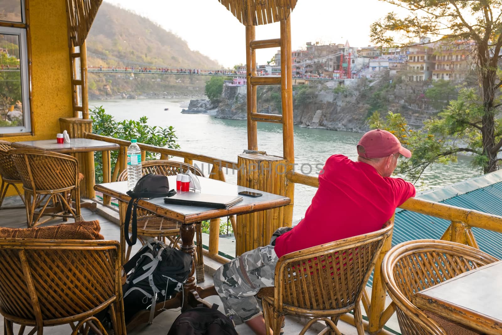 Tourist looking at a great view at the river Ganges at Laxman Jhula in India