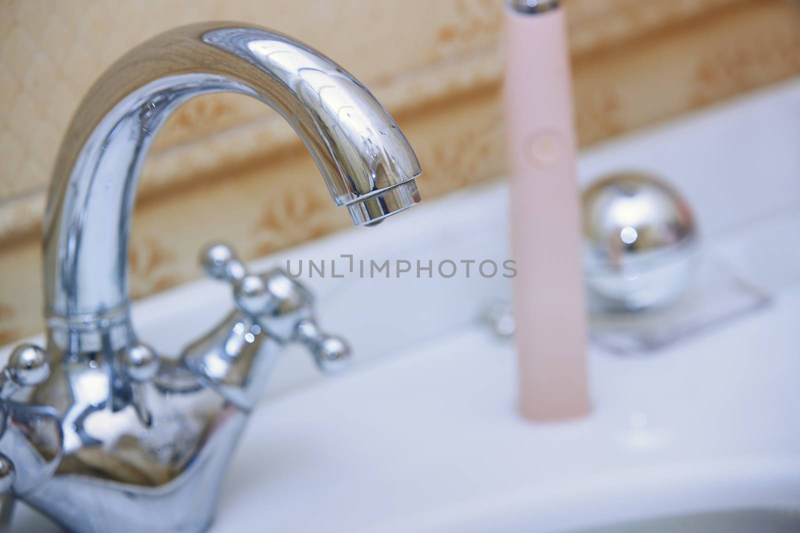 Close-up photo of the chrome water tap and sink