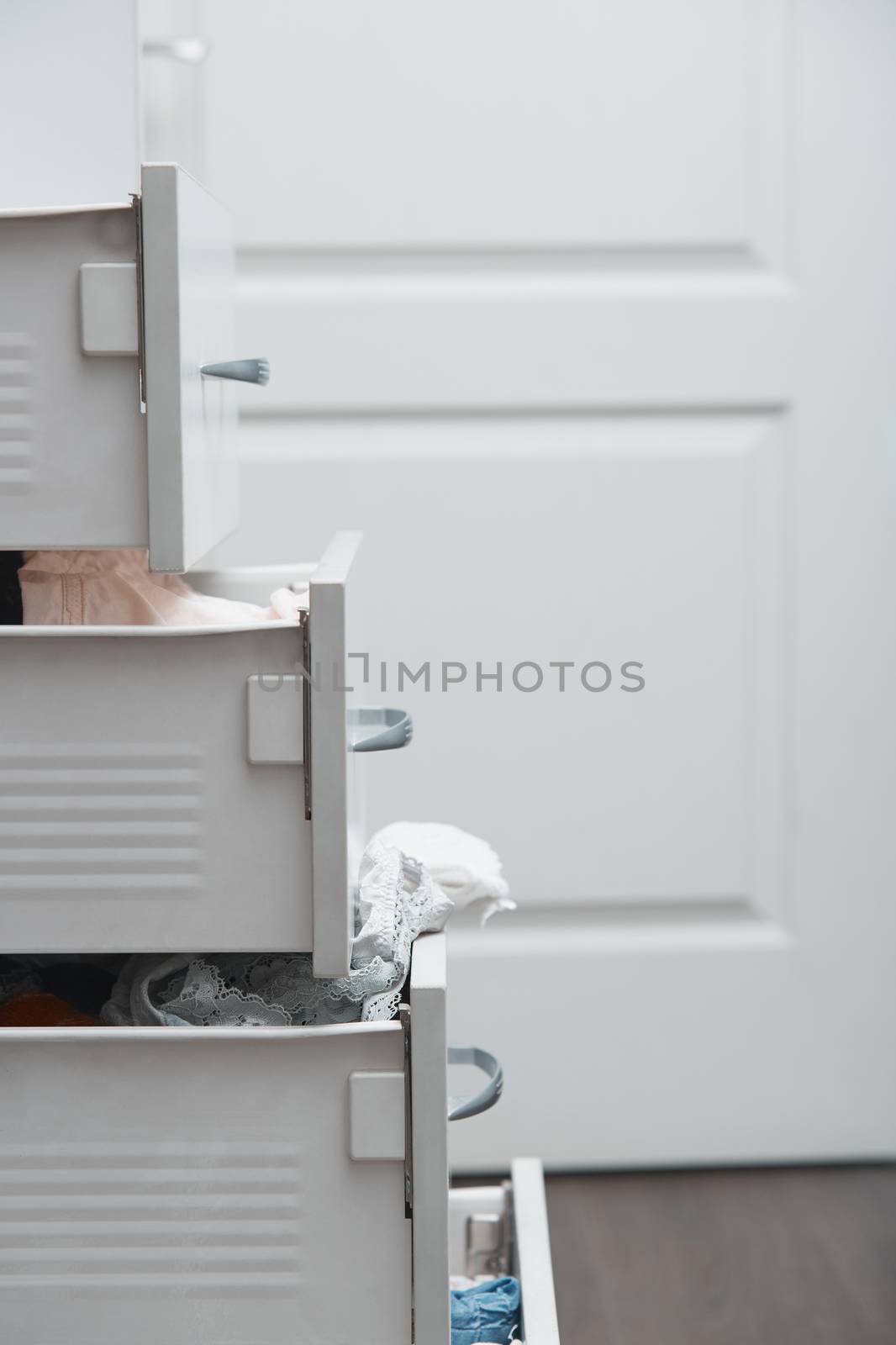 Messy clothes in wardrobe. Vertical photo