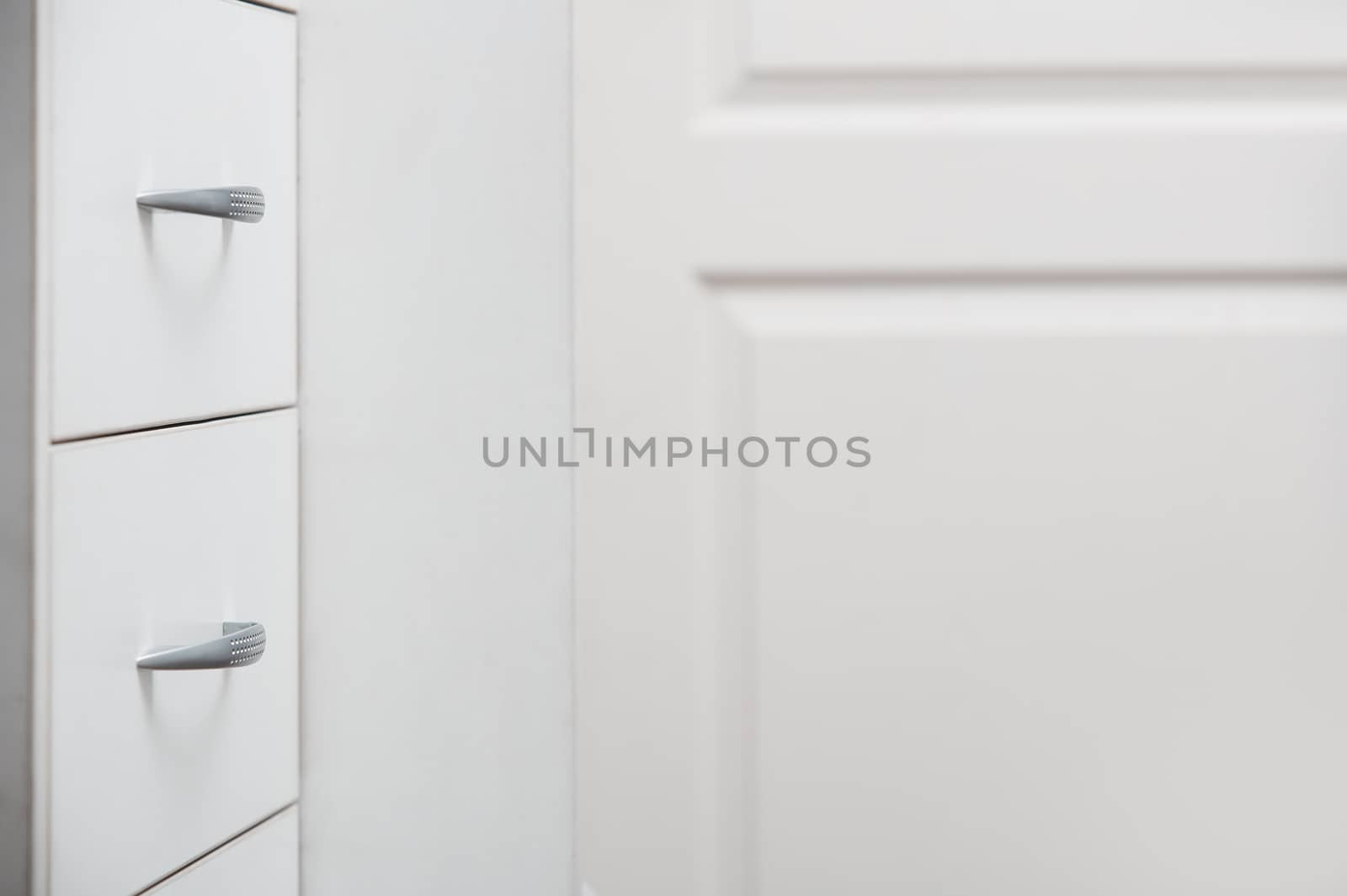 Cabinet with sliding trays and chrome handles. Horizontal photo