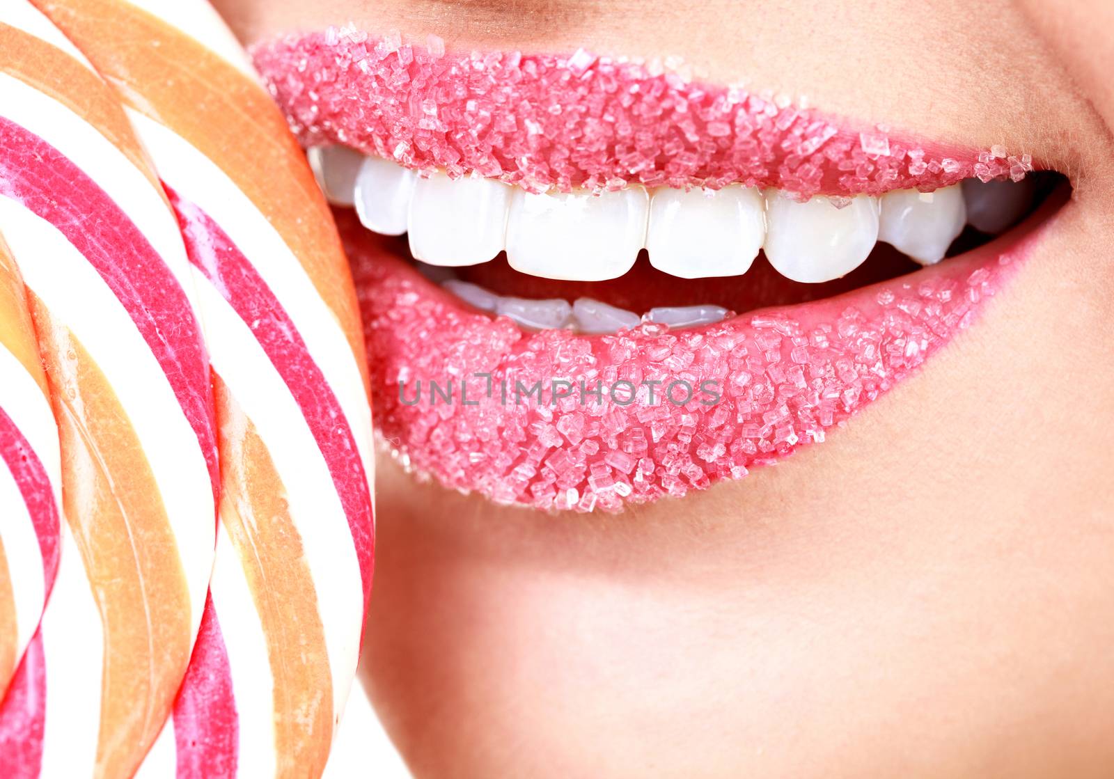 Closeup of woman's lips covered by sugar and big lollypop