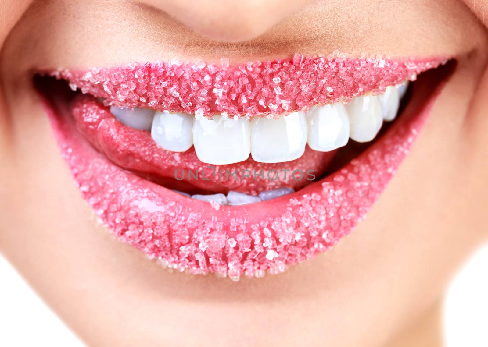 Closeup of woman's lips covered with sugar. Toothy smile