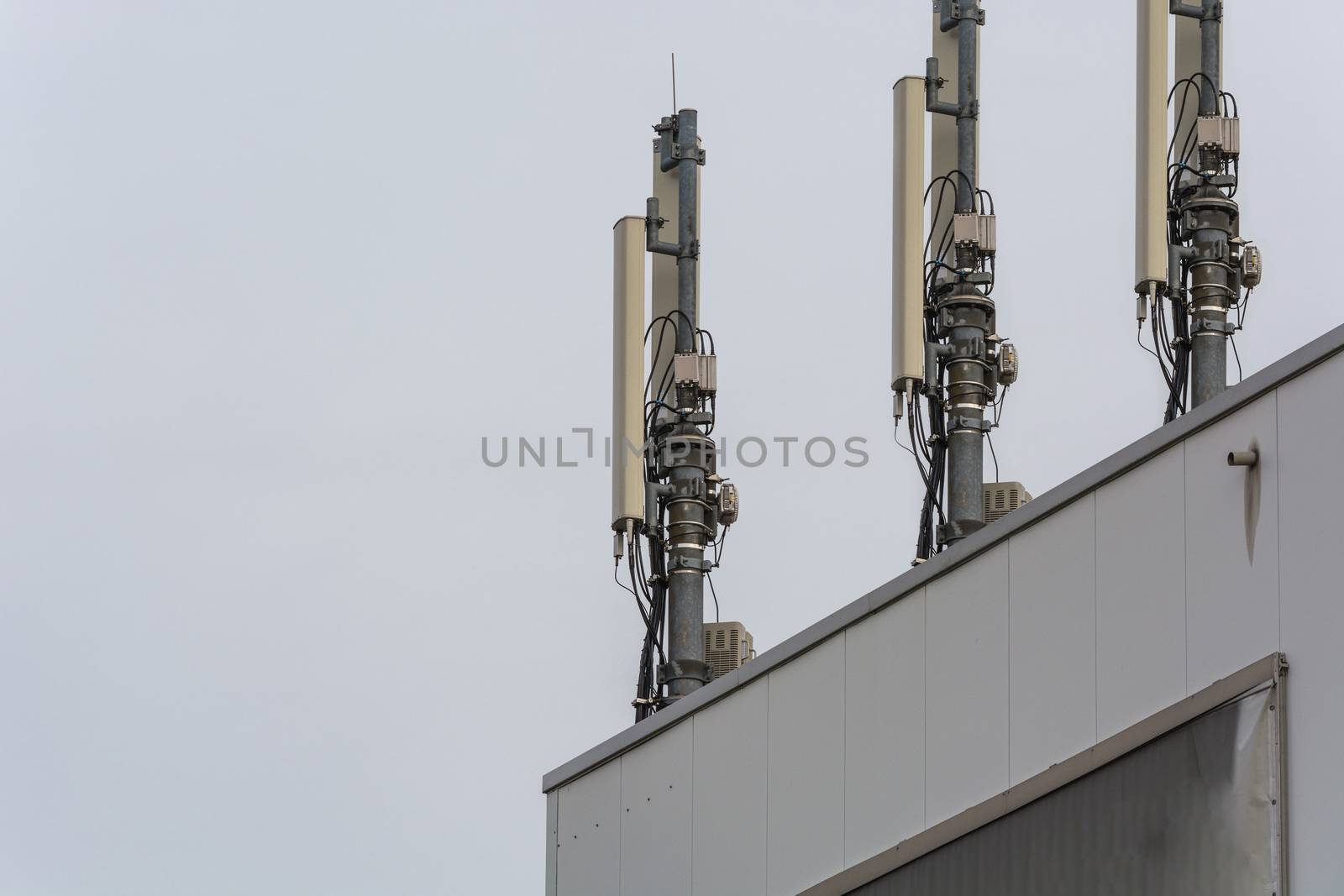 Antenna, telecommunications tower on a roof, wireless telecommunications concept.