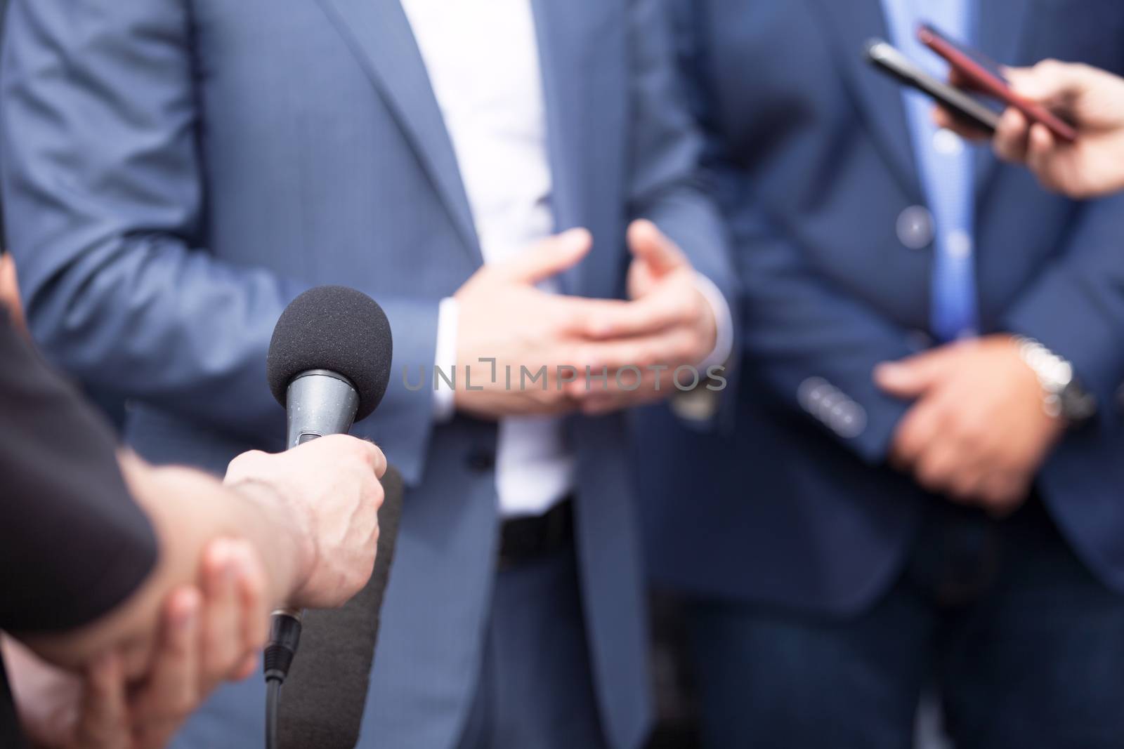 Journalists making interview with businessperson, politician or spokesperson. Press conference.