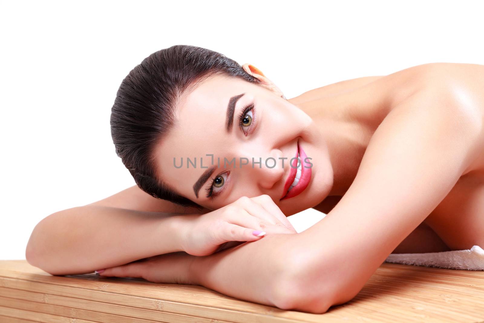 Young beautiful woman relaxing at spa salon, isolated on white background